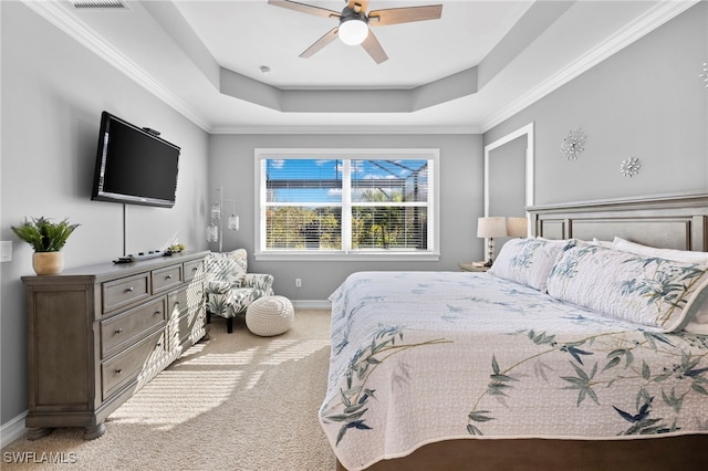 carpeted bedroom featuring crown molding, ceiling fan, and a tray ceiling