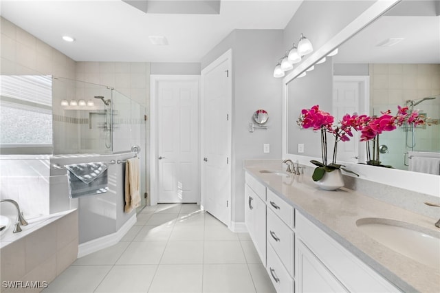 bathroom with tile patterned flooring, plus walk in shower, and vanity