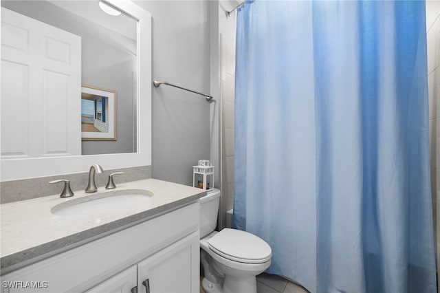 bathroom with vanity, tile patterned floors, and toilet