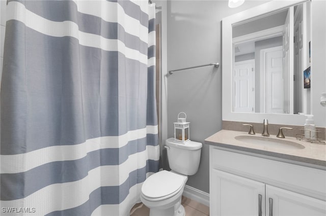 bathroom featuring tile patterned flooring, vanity, and toilet