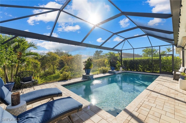 view of pool with a patio, a lanai, and pool water feature