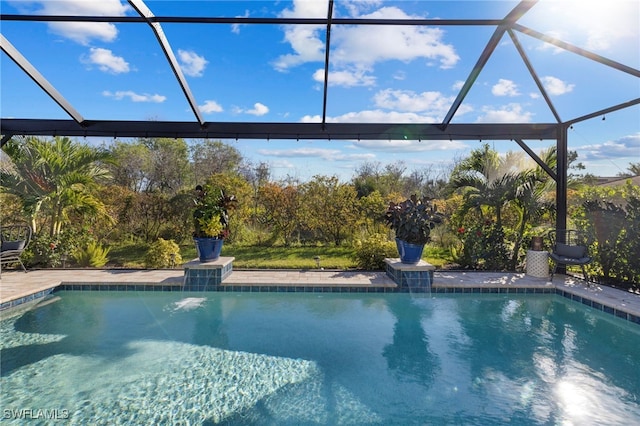 view of pool with glass enclosure