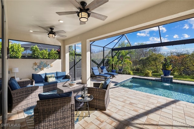 view of pool featuring pool water feature, ceiling fan, glass enclosure, an outdoor living space, and a patio area