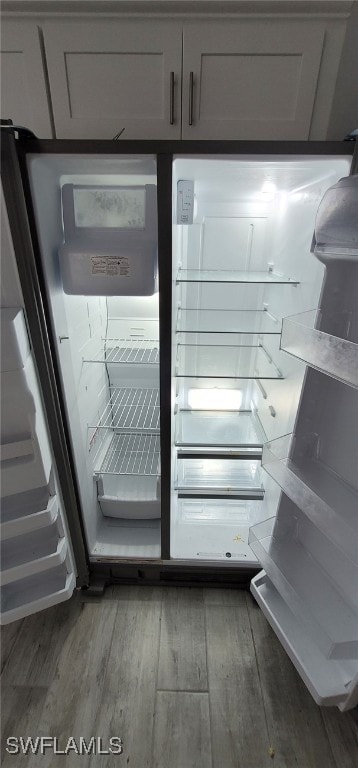 details featuring refrigerator and dark hardwood / wood-style flooring