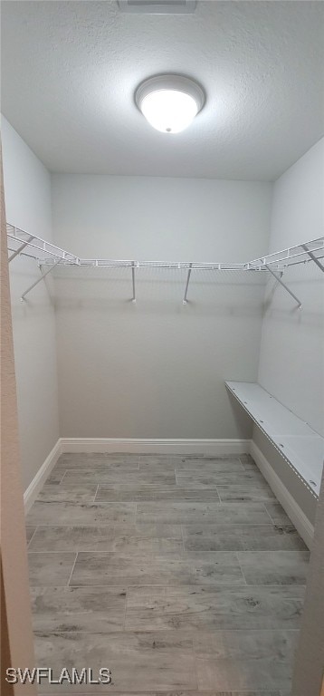 spacious closet featuring hardwood / wood-style floors