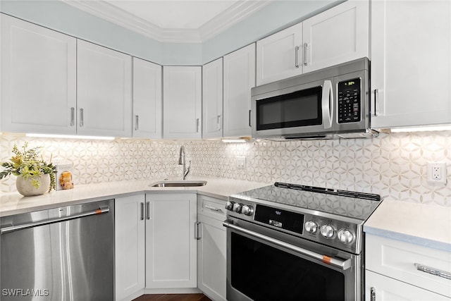 kitchen featuring white cabinets, stainless steel appliances, tasteful backsplash, and sink