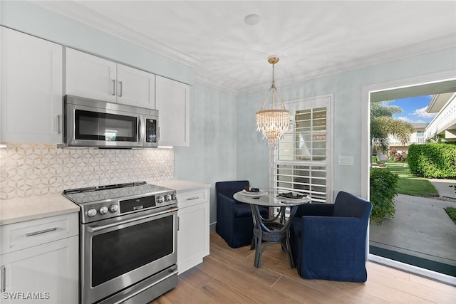 kitchen featuring light hardwood / wood-style floors, white cabinetry, backsplash, and appliances with stainless steel finishes