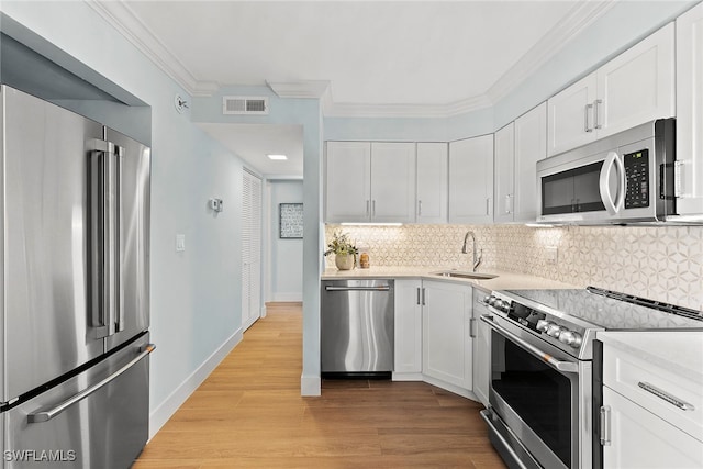 kitchen with white cabinets, sink, and appliances with stainless steel finishes