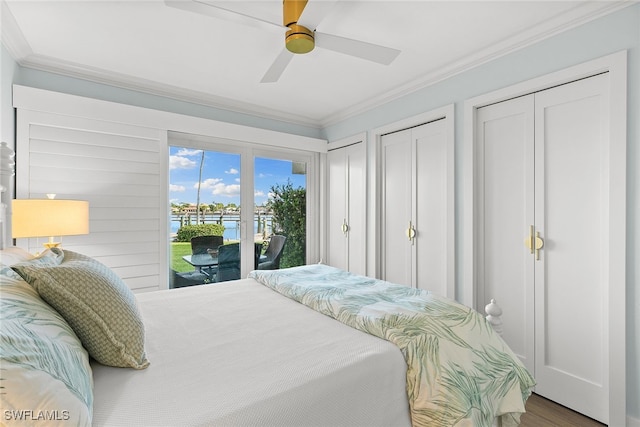 bedroom featuring access to outside, ceiling fan, ornamental molding, wood-type flooring, and multiple closets