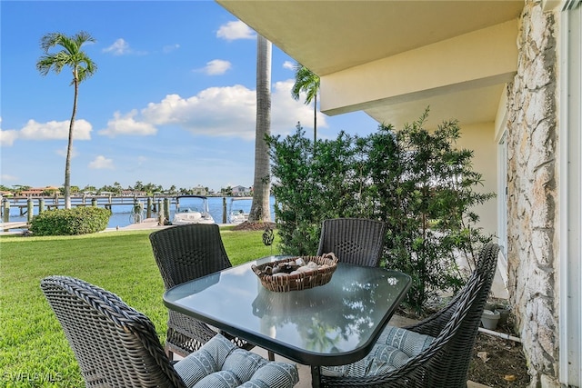 balcony with a boat dock and a water view