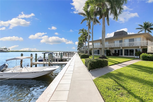 dock area with a yard and a water view