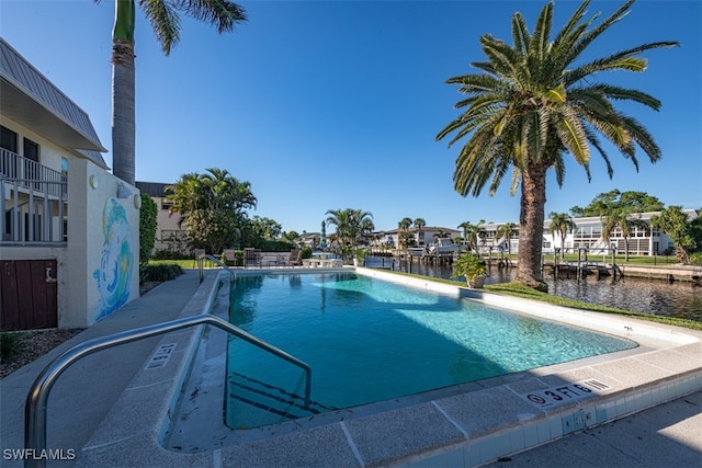 view of pool featuring a water view