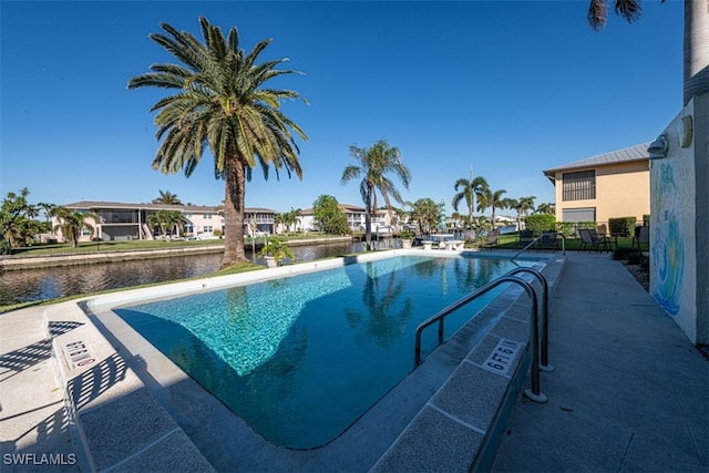 view of swimming pool with a water view