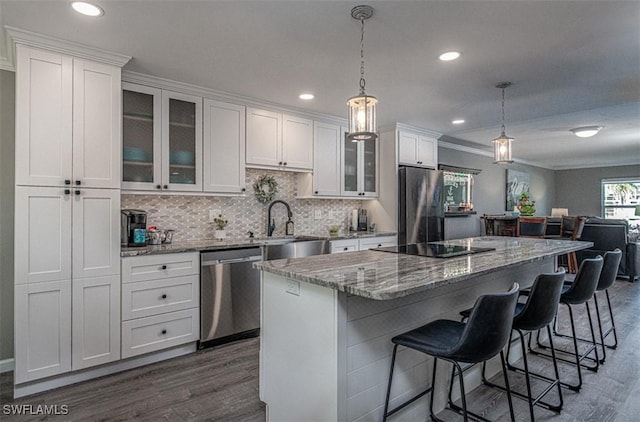 843 SE 46th Ln Unit 1, Cape Coral, FL 33904 - kitchen with appliances with stainless steel finishes, dark wood finished floors, a sink, a center island, and white cabinets