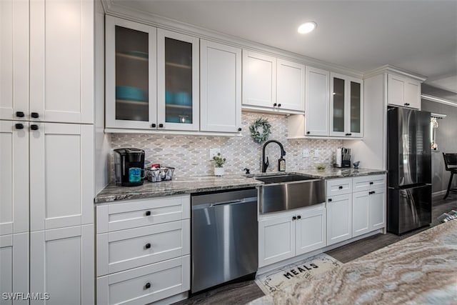 kitchen with dishwasher, refrigerator, light stone counters, and sink