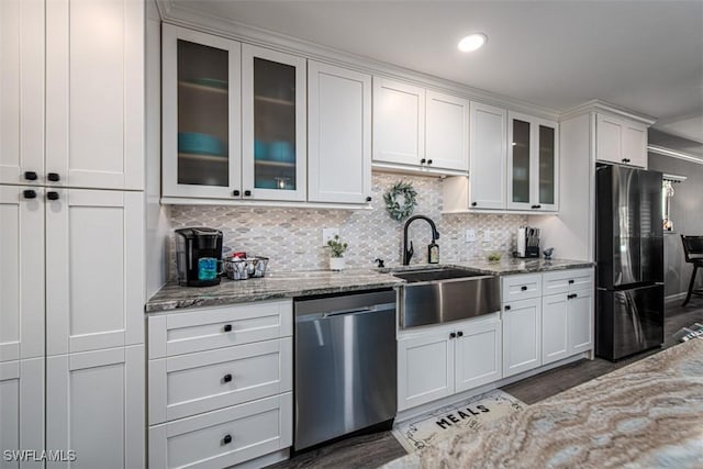 843 SE 46th Ln Unit 1, Cape Coral, FL 33904 - kitchen with stainless steel dishwasher, freestanding refrigerator, a sink, decorative backsplash, and light stone countertops