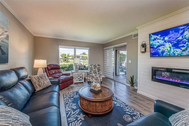 living room with a fireplace, hardwood / wood-style floors, and crown molding