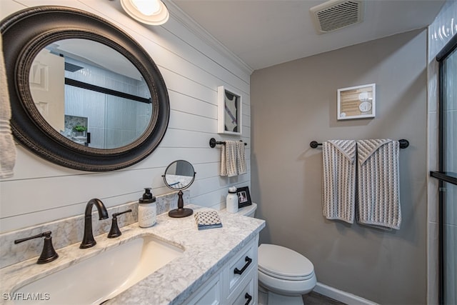 bathroom featuring walk in shower, wood walls, toilet, vanity, and ornamental molding