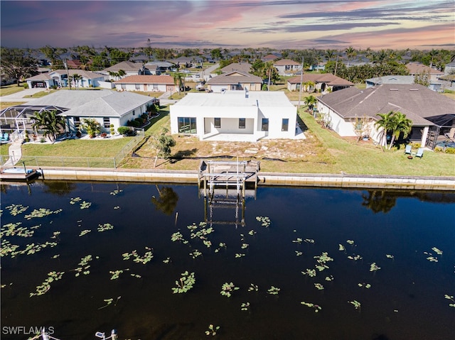 aerial view at dusk with a water view