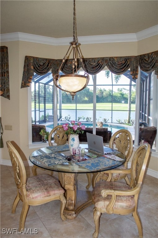 tiled dining room featuring a wealth of natural light and ornamental molding