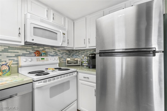 kitchen featuring white cabinetry, stainless steel appliances, and tasteful backsplash