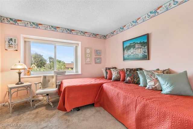 bedroom featuring carpet floors and a textured ceiling