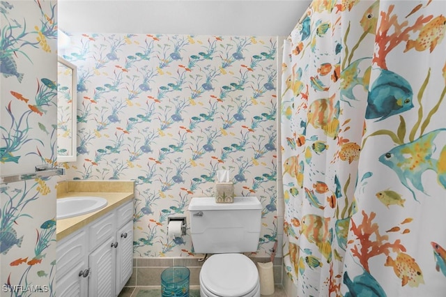 bathroom with tile patterned flooring, vanity, and toilet