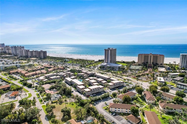 drone / aerial view with a beach view and a water view