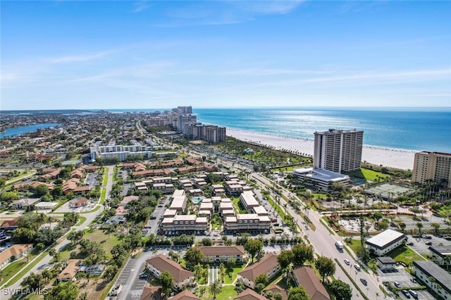 drone / aerial view featuring a water view and a beach view