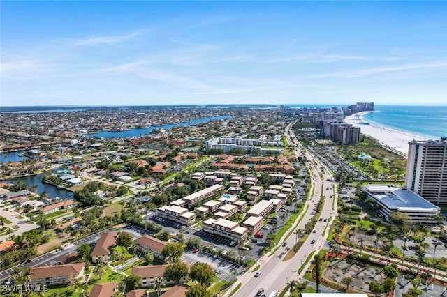 aerial view with a water view and a beach view