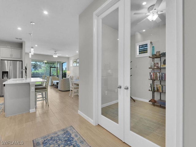 interior space with light wood-type flooring and french doors