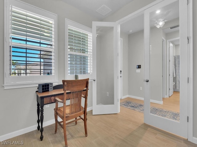 home office featuring light hardwood / wood-style flooring and french doors