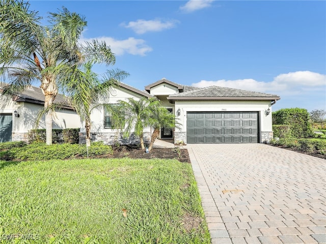 view of front of house featuring a front yard and a garage