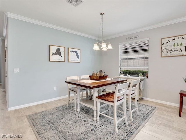 dining room featuring visible vents, baseboards, an inviting chandelier, and ornamental molding