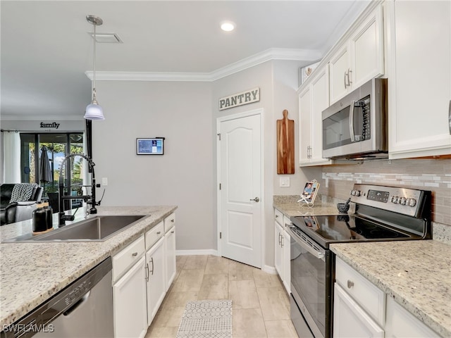 19431 Elston Way, Estero, FL 33928 - kitchen with appliances with stainless steel finishes, tasteful backsplash, ornamental molding, white cabinets, and hanging light fixtures