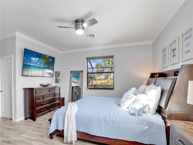 bedroom featuring ceiling fan, light hardwood / wood-style floors, and crown molding