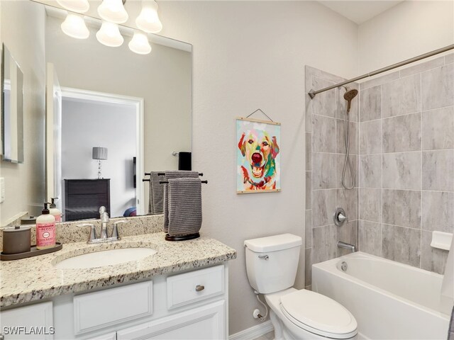 full bathroom with toilet, vanity, and tiled shower / bath