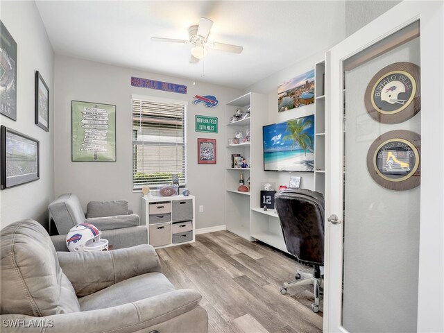 office with light wood-type flooring, baseboards, and a ceiling fan