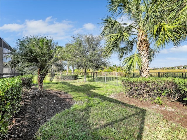 view of yard featuring a lanai and a fenced backyard