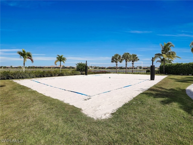 view of property's community with volleyball court and a yard