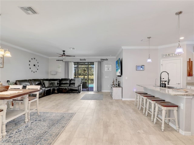 19431 Elston Way, Estero, FL 33928 - dining area with ceiling fan, crown molding, and light wood-type flooring