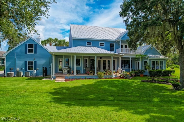 rear view of property with a lawn, a balcony, and a porch