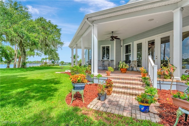 view of yard featuring ceiling fan and a porch