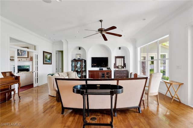 interior space featuring light hardwood / wood-style flooring, ceiling fan, and ornamental molding