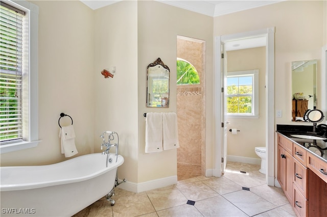 bathroom with vanity, crown molding, a bath, tile patterned flooring, and toilet