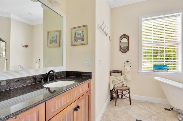 bathroom featuring tile patterned flooring, vanity, a bathtub, and crown molding