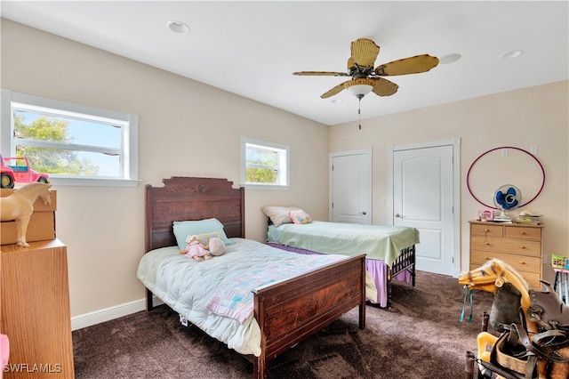 bedroom featuring ceiling fan and dark carpet