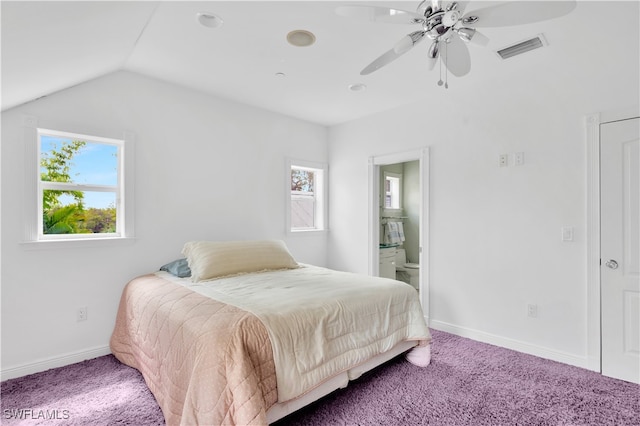 carpeted bedroom with ceiling fan, lofted ceiling, connected bathroom, and multiple windows