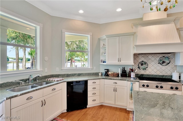 kitchen with light stone counters, ornamental molding, dishwasher, light hardwood / wood-style floors, and white cabinetry