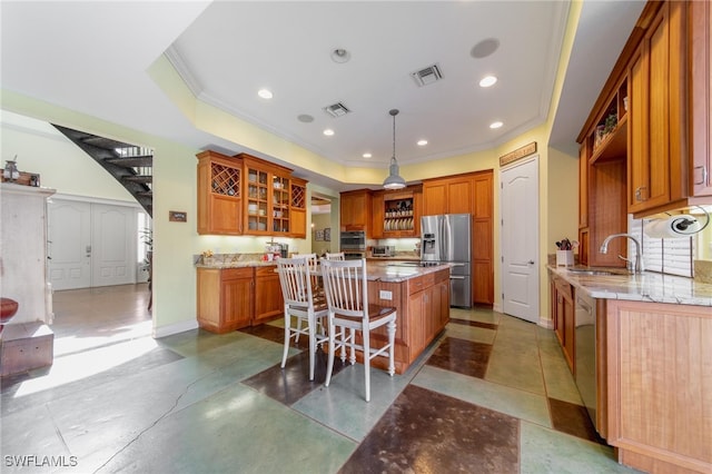 kitchen featuring a center island, a kitchen breakfast bar, sink, hanging light fixtures, and stainless steel appliances